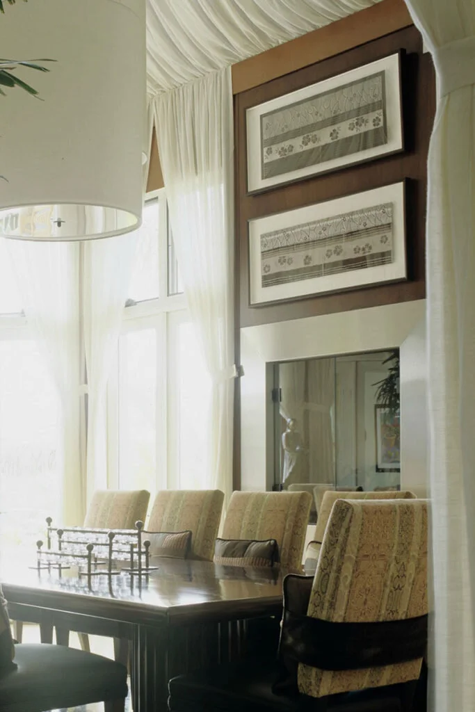 A contemporary fireplace blends in with the muted and neutral colors of a dining room.