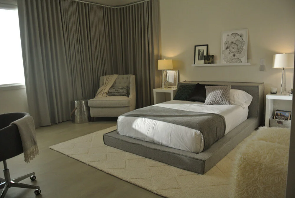 Taupe and grey bedroom with ceiling to floor window treatments.