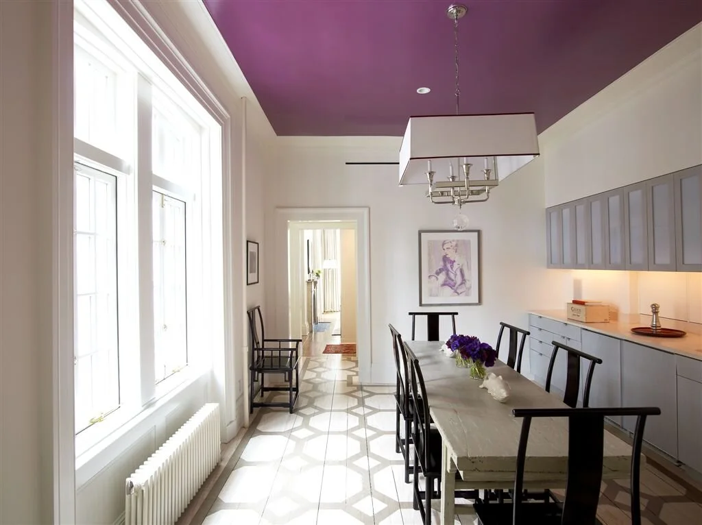 A dining room featuring a purple painted ceiling