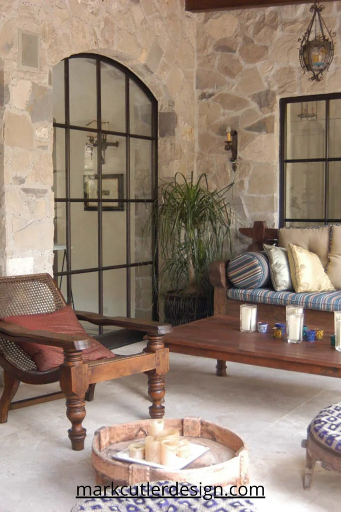 This eclectic outdoor living space has a Morrocan feel and a general sense of the exotic. With a blend of antiques and patterned fabrics, the festive space is designed to transport you to an exotic location.