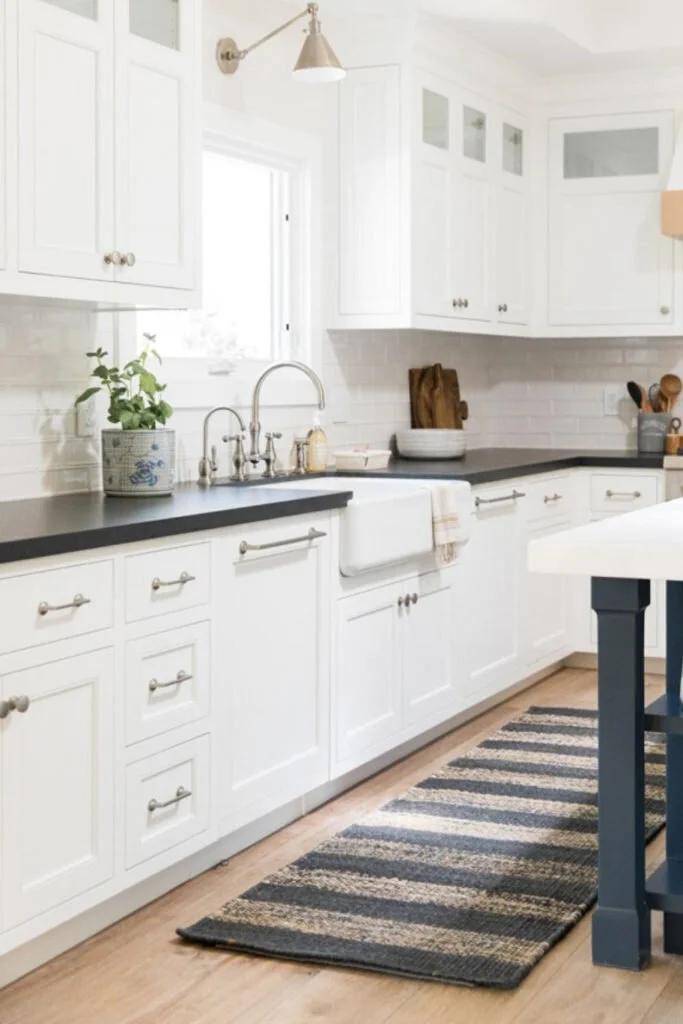 A classic kitchen design with white cabinets and a blue countertop.