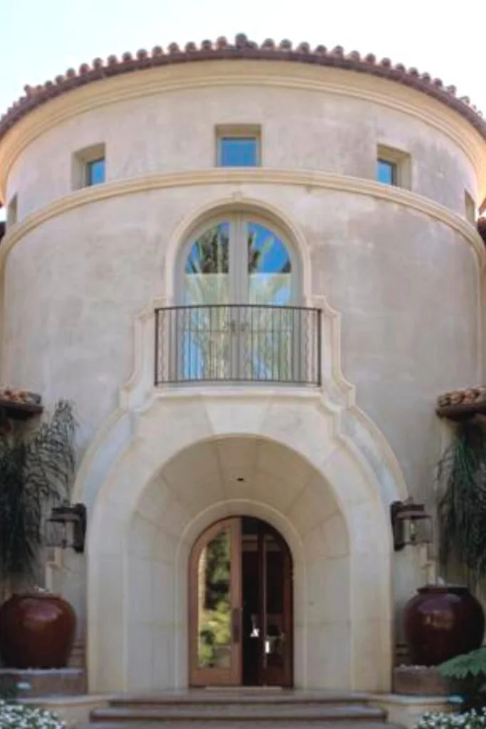 A grand double heigh entry way with another set of doors above the entry doors.