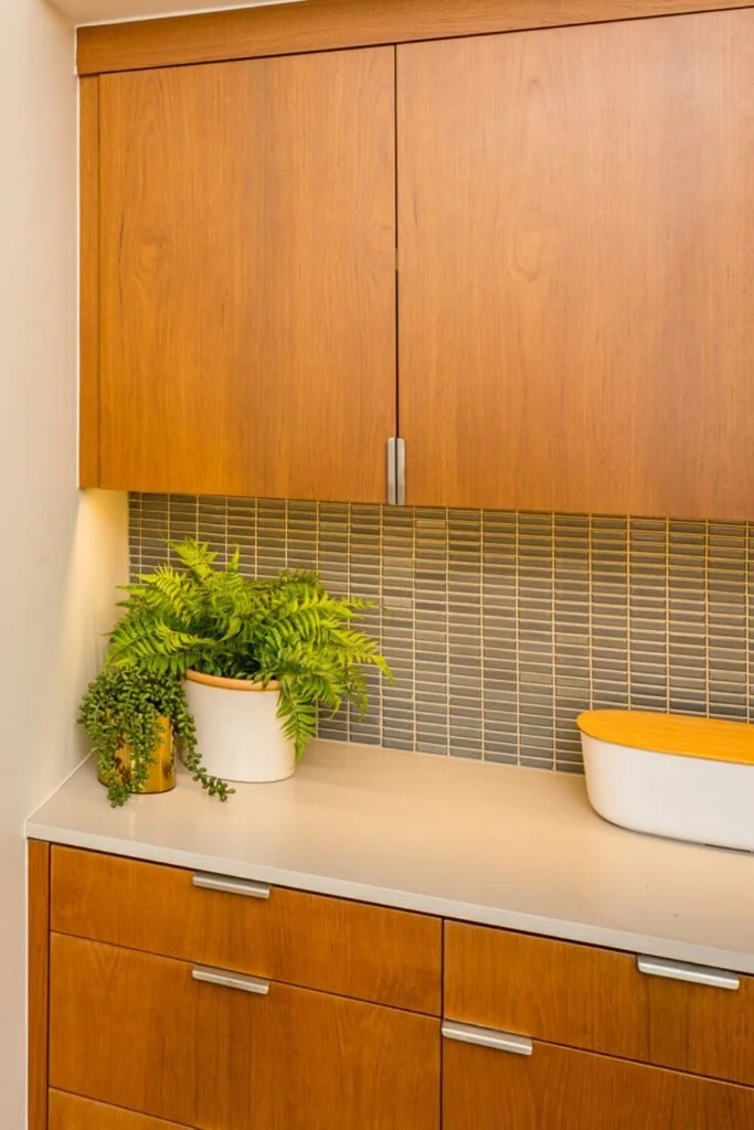 The scale of countertops and backsplash tiles can make a big difference in older kitchens like this one.