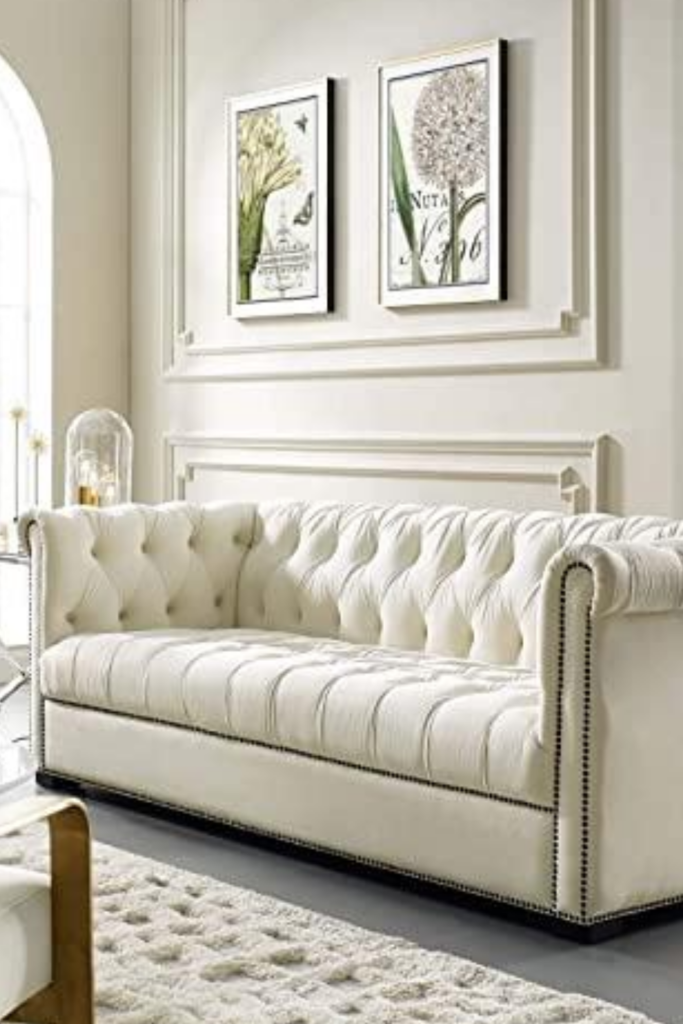 A white Chesterfield sofa that refers to a quilted leather design commissioned by William Stanhope, the fourth Earl of Chesterfield in the mid 17th century.
