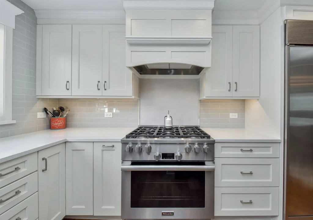 A kitchen using a pale gray color on its cabinets.