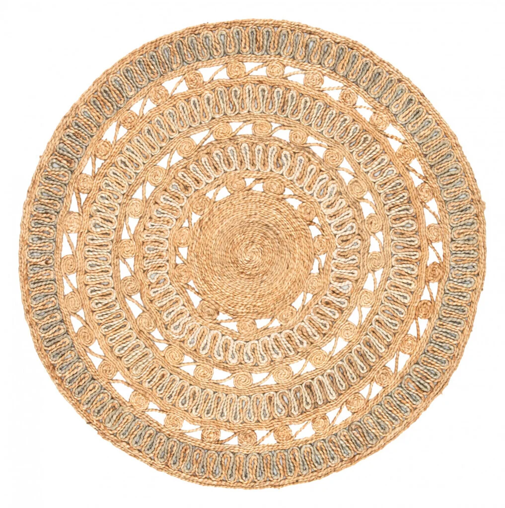 A woven natural patterned rug lends itself to a circular form and helps warm up a sitting room.